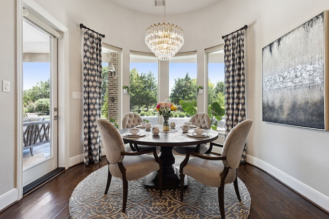 dining space with an inviting chandelier and dark wood-type flooring