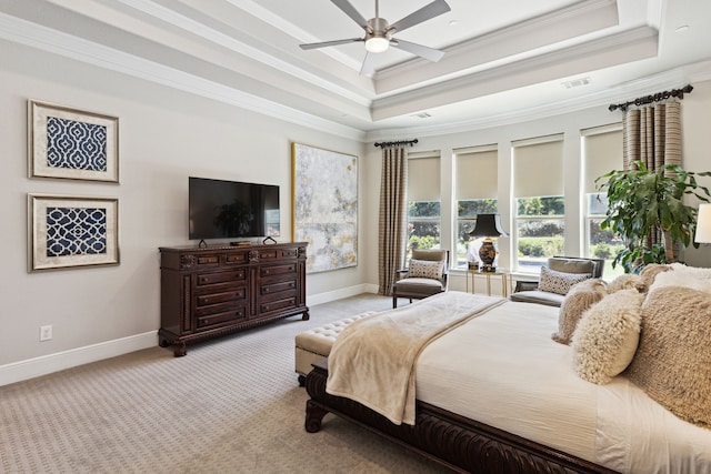 carpeted bedroom featuring ornamental molding, ceiling fan, and a raised ceiling