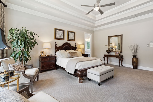 bedroom featuring ceiling fan, a tray ceiling, crown molding, and light carpet