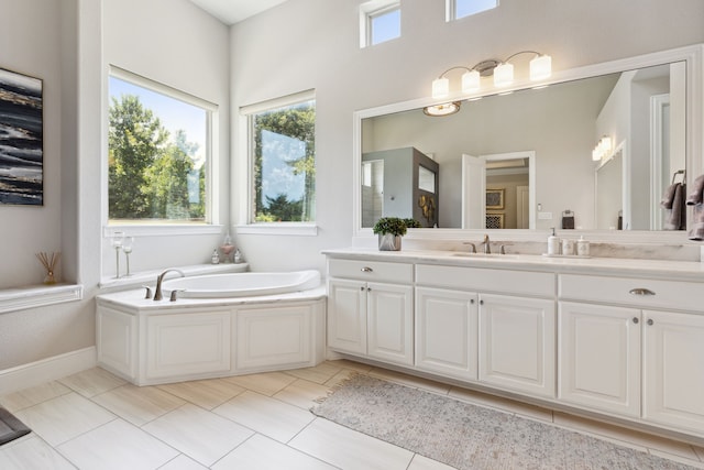 bathroom with vanity and a bath