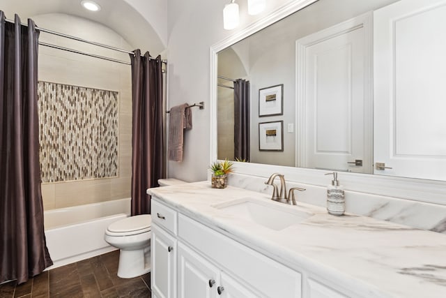 full bathroom featuring shower / bathtub combination with curtain, vanity, and toilet