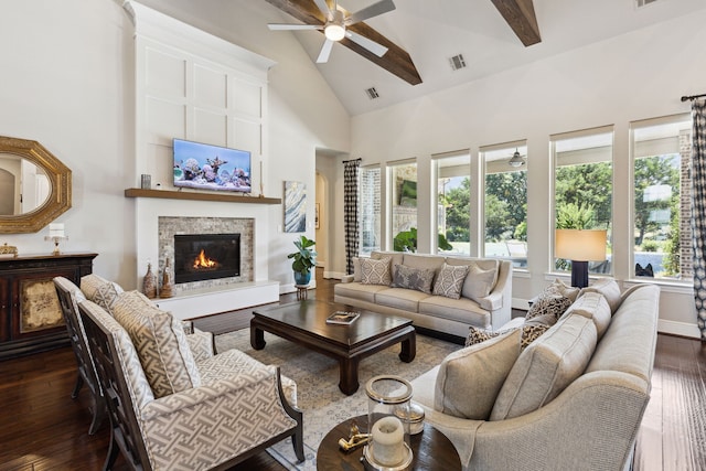 living room with high vaulted ceiling, beam ceiling, ceiling fan, and dark wood-type flooring