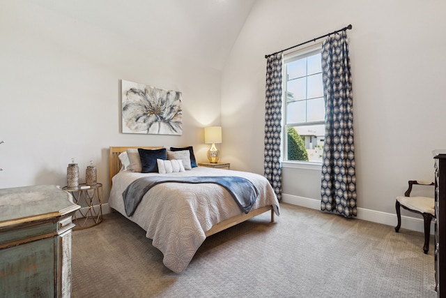 carpeted bedroom with lofted ceiling