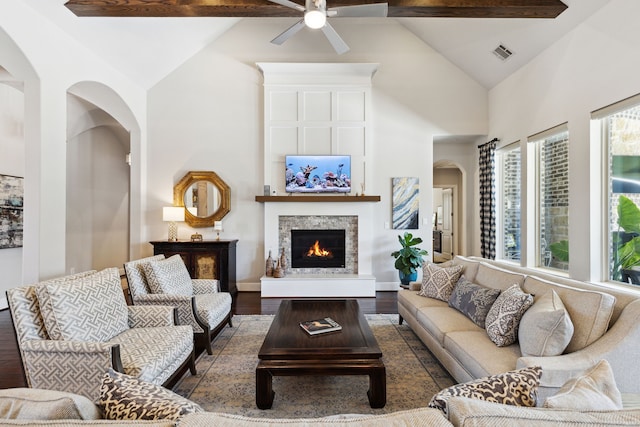 living room with beam ceiling, a fireplace, high vaulted ceiling, hardwood / wood-style floors, and ceiling fan