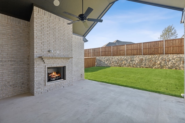 view of patio / terrace featuring an outdoor brick fireplace and ceiling fan