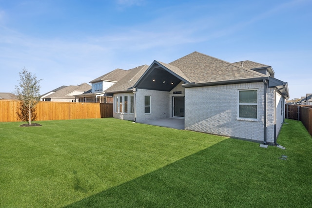 back of property featuring a yard and a patio area