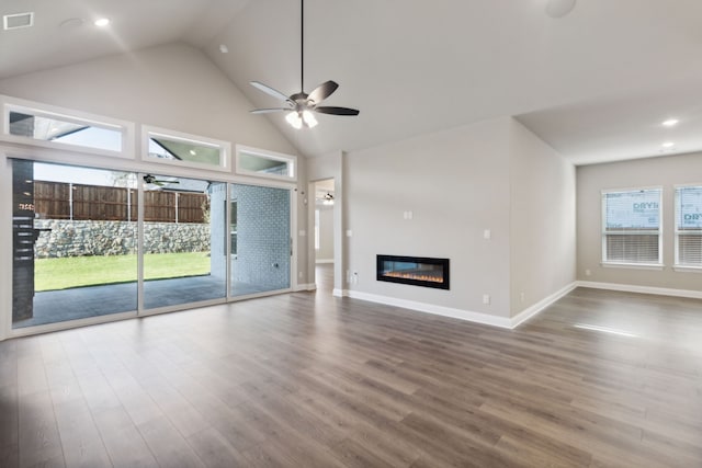 unfurnished living room with ceiling fan, high vaulted ceiling, and hardwood / wood-style flooring