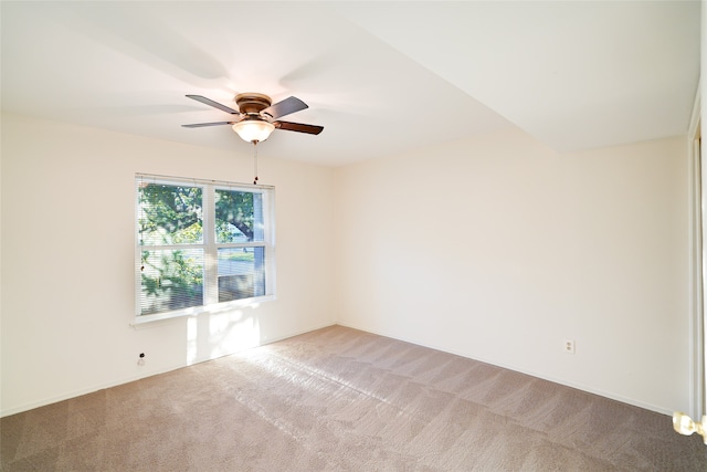 empty room with a ceiling fan and light colored carpet