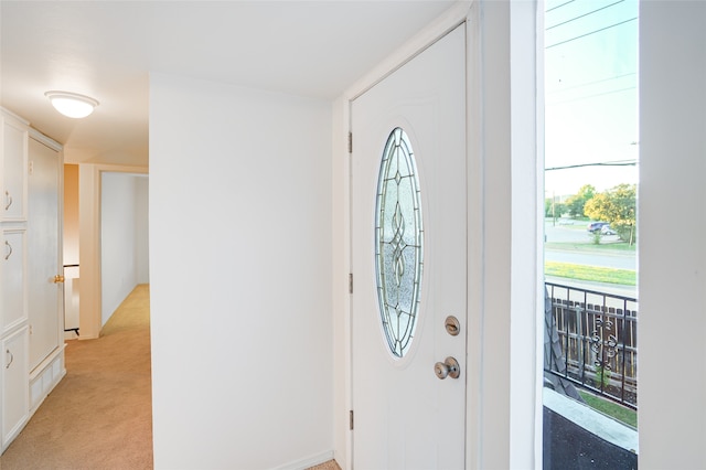 entryway featuring light carpet