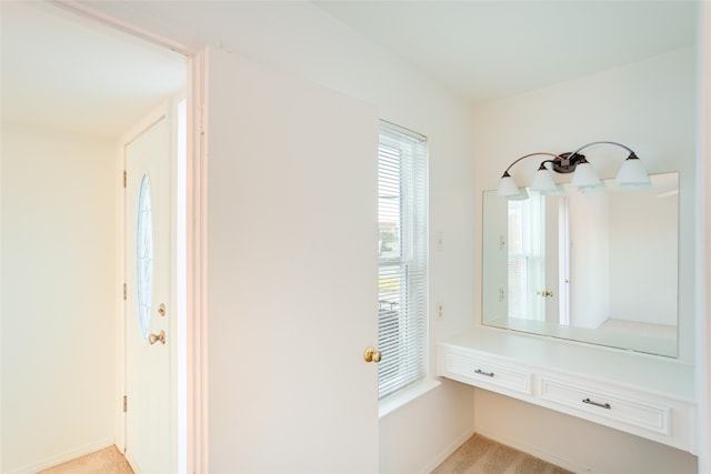 mudroom with light colored carpet and baseboards