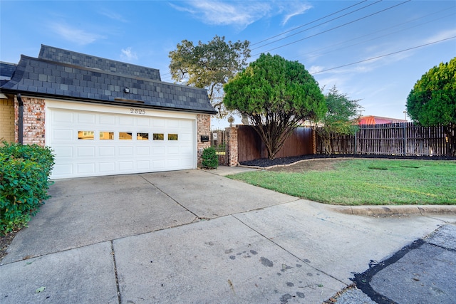 view of front of home with a front yard and a garage