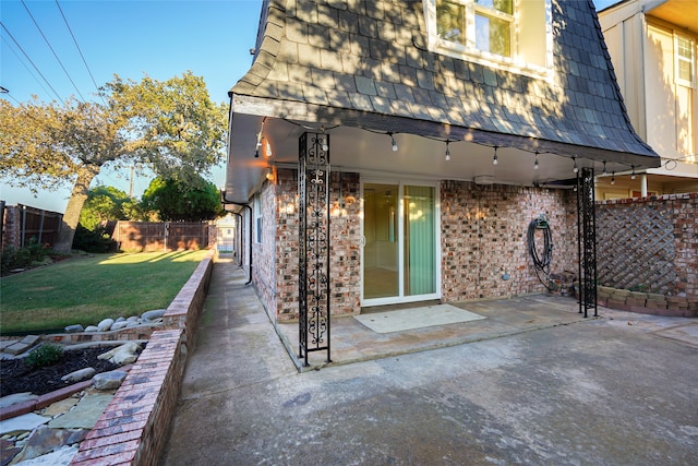 rear view of house featuring a yard and a patio