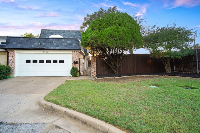 view of front facade with a lawn and a garage