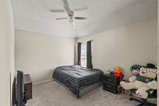 carpeted bedroom featuring ceiling fan and a textured ceiling