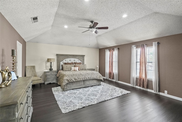 bedroom with ceiling fan, vaulted ceiling, a textured ceiling, and dark hardwood / wood-style flooring