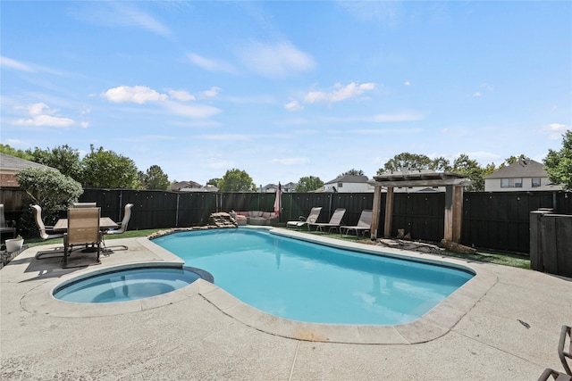 view of swimming pool featuring a patio and an in ground hot tub