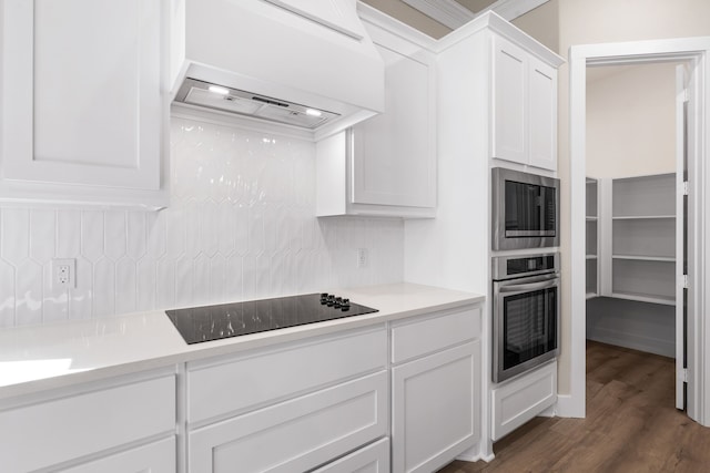 kitchen featuring extractor fan, dark wood finished floors, white cabinetry, light countertops, and appliances with stainless steel finishes