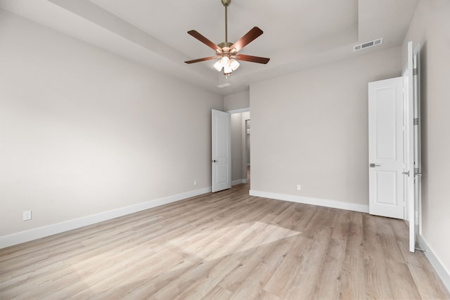 unfurnished bedroom featuring light wood finished floors, visible vents, and baseboards