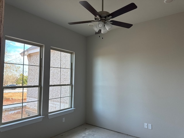 spare room featuring a wealth of natural light and ceiling fan