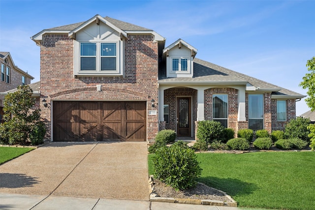 view of front facade with a garage and a front lawn