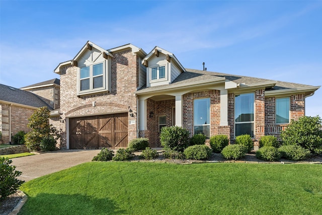 view of front of property with a front yard and a garage