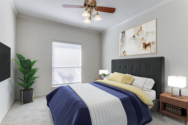 bedroom with ornamental molding, a textured ceiling, light colored carpet, and ceiling fan