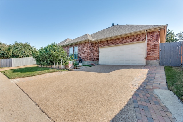 view of front of house featuring a front yard and a garage