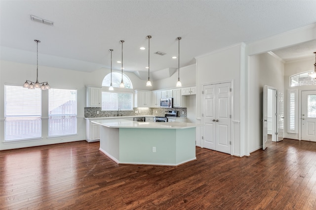 kitchen with white cabinets, dark wood-type flooring, plenty of natural light, and a kitchen island