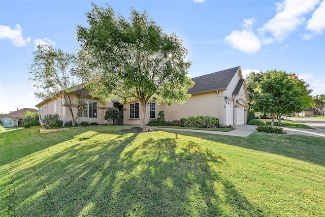 view of front of home featuring a front yard and a garage