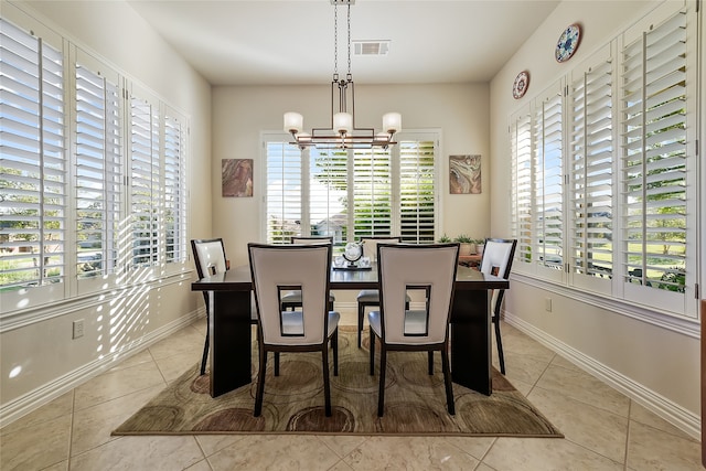 tiled dining room with a notable chandelier