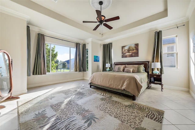 bedroom with ceiling fan, light tile patterned floors, crown molding, and a tray ceiling