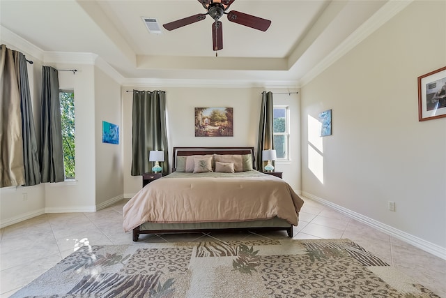 bedroom with light tile patterned floors, a raised ceiling, ceiling fan, and ornamental molding