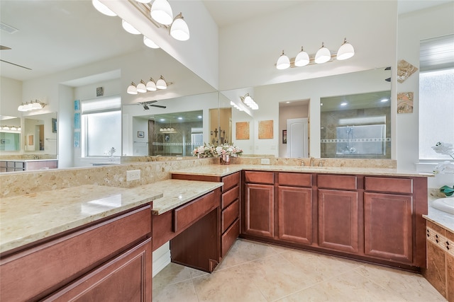 bathroom featuring a tile shower, ceiling fan, tile patterned flooring, and vanity