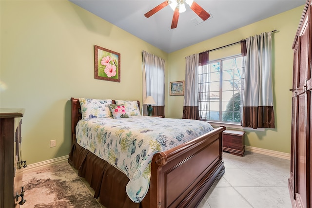 tiled bedroom featuring ceiling fan