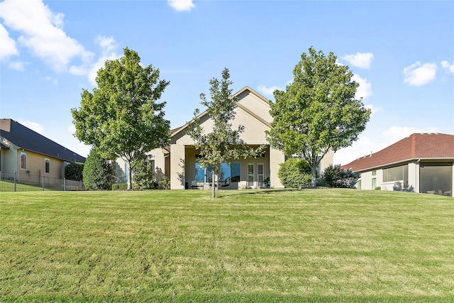 rear view of house featuring a lawn