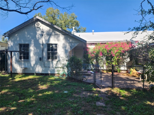 rear view of house with a yard