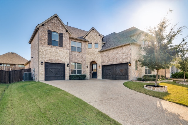 view of front of house featuring a garage and a front lawn