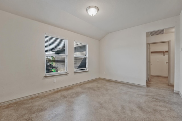 spare room with lofted ceiling