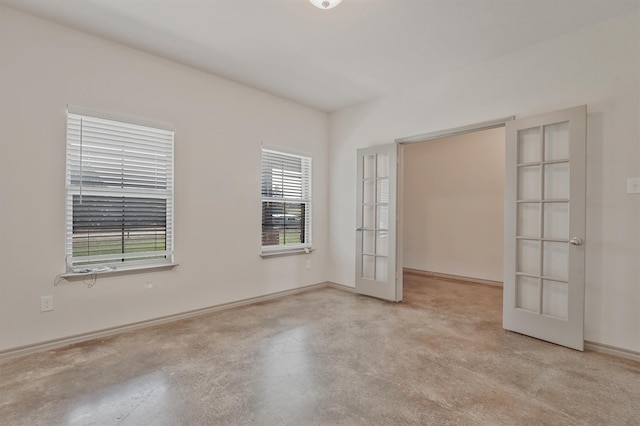 unfurnished room featuring plenty of natural light and french doors