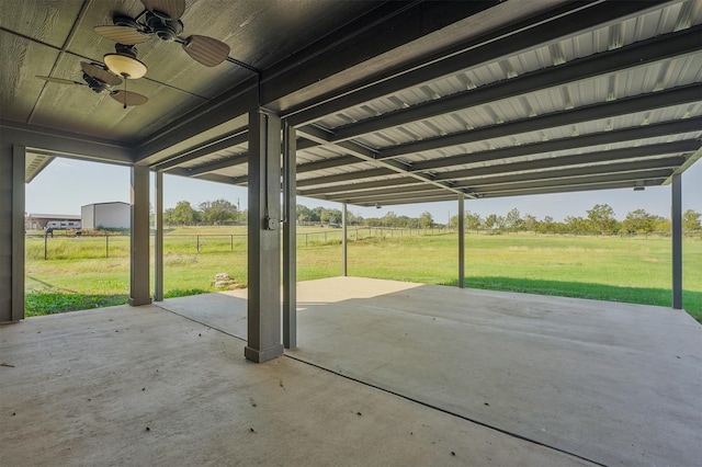 view of patio with ceiling fan and a rural view