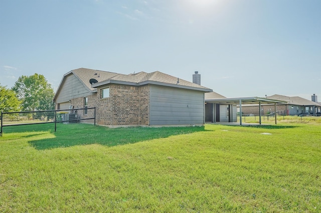 back of house with a patio and a lawn