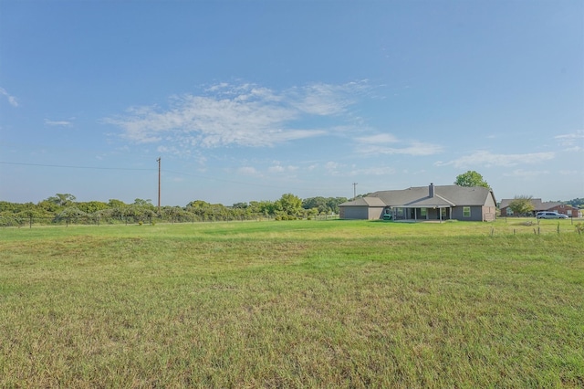 view of yard with a rural view