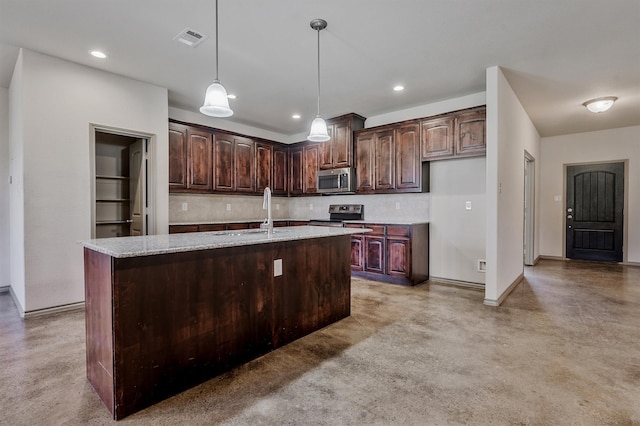 kitchen with dark brown cabinets, a kitchen island with sink, sink, and stainless steel appliances