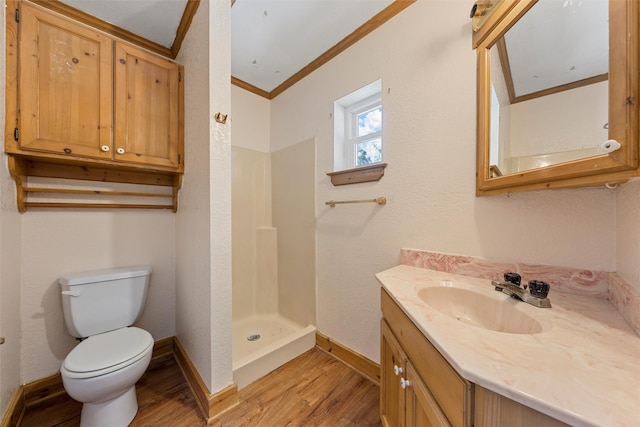 bathroom featuring a shower, vanity, crown molding, wood-type flooring, and toilet