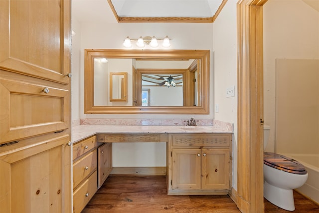 bathroom featuring ceiling fan, vanity, hardwood / wood-style floors, and toilet