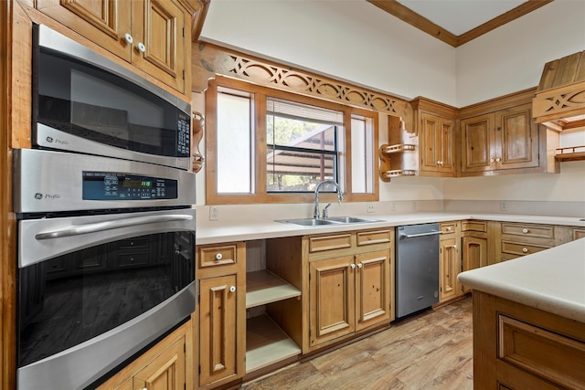 kitchen with appliances with stainless steel finishes, crown molding, light hardwood / wood-style floors, and sink