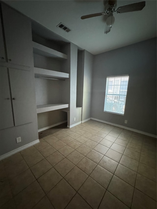 interior space featuring ceiling fan and light tile patterned floors