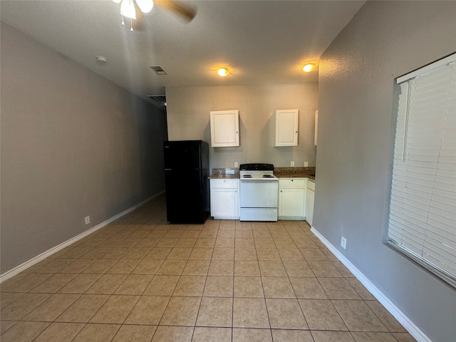 kitchen featuring light tile patterned flooring, white electric range, black refrigerator, and white cabinetry