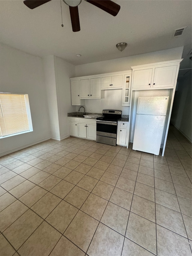 kitchen with white cabinets, white fridge, stainless steel electric stove, light tile patterned floors, and ceiling fan