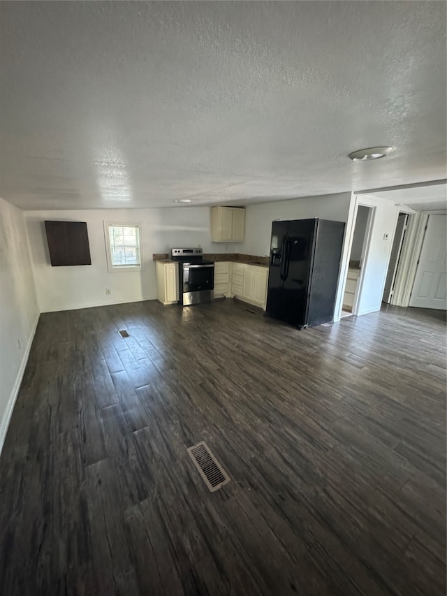 unfurnished living room featuring a textured ceiling and dark wood-type flooring